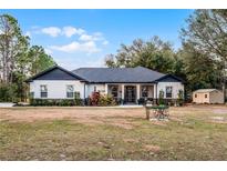 Beautiful craftsman style home with a large front yard and detached shed at 6832 Maryland Ave, Groveland, FL 34736