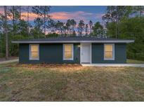 Charming single-story home with a newly landscaped front yard and a fresh exterior paint job at 15323 Sw 25Th Pl, Ocala, FL 34482