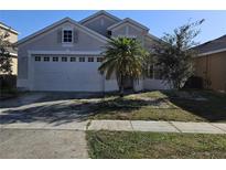 Charming single-Gathering home featuring a spacious two-car garage and a well-maintained front yard with mature trees at 1745 Caribou Hunt Trl, Orlando, FL 32824