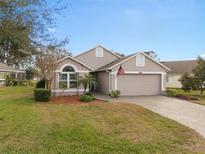 Charming home with a well-manicured lawn, neutral colors, and a lovely paver driveway at 3518 Westerham Dr, Clermont, FL 34711
