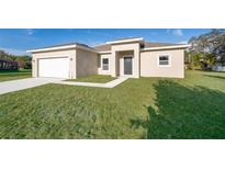 Newly constructed one-story home with a two-car garage and landscaped lawn at 610 Messina Way, Kissimmee, FL 34758