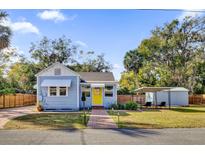 Charming single-story home with a cheerful yellow front door, brick pathway, and lush green lawn at 805 Hackett Ct, Mount Dora, FL 32757