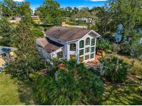 Aerial view of two story house with large deck and surrounding landscape at 2450 Topping Pl, Eustis, FL 32726