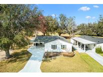 Charming one-story home with well-maintained lawn and mature trees, located on a quiet street at 525 Bonita Dr, Lady Lake, FL 32159