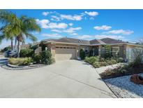 Well-maintained house with landscaped front yard, driveway, and two-car garage at 7592 Se 170Th Longview Ln, The Villages, FL 32162