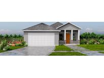 Modern one-story home with gray siding, attached garage, and landscaped front yard at Lot 4 Se 162Nd Place, Weirsdale, FL 32195