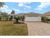 Single-story home with a paved driveway and landscaped lawn at 1514 Vandam St, The Villages, FL 32162