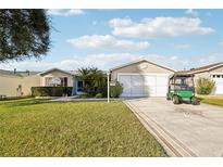 Inviting single-story home features a well-manicured lawn, mature landscaping, and a two-car garage at 3319 Thorncrest Dr, The Villages, FL 32162