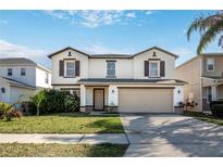 Charming two-story home with a well-manicured lawn and attached two-car garage, offering great curb appeal at 16825 Sunrise Vista Dr, Clermont, FL 34714