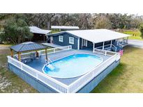 Inviting pool area features a gazebo and a spacious deck, perfect for outdoor entertaining at 2685 Cr 776, Webster, FL 33597