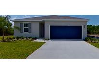Charming single-story home with a well-manicured lawn and a two-car garage at 2968 Supermarine Rd, Tavares, FL 32778