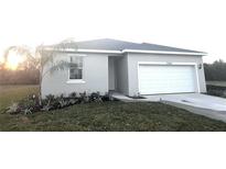 Charming single-story home with attached two-car garage and freshly landscaped front yard at 2968 Supermarine Rd, Tavares, FL 32778