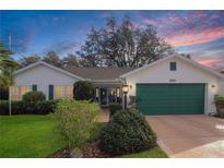 Charming single-story home featuring a well-maintained lawn and attached two-car garage at 4034 River Crest Cir, Leesburg, FL 34748