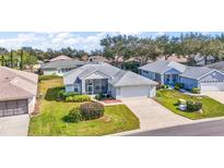 Charming single-story home with attached garage, screened porch, and well-manicured lawn in a friendly neighborhood at 5095 China Sea Dr, Tavares, FL 32778