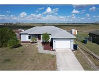 Charming single-story home with a well-maintained yard, driveway, and two-car garage at 119 Cory Ct, Auburndale, FL 33823