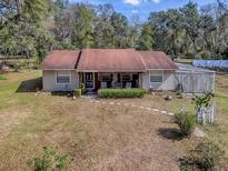 Charming single-story home with a cozy front porch and well-maintained yard at 11915 Cr 680, Webster, FL 33597