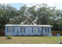 Charming single-story home features blue shutters, metal roof and lovely front yard at 1846 Fruitland Park Blvd, Fruitland Park, FL 34731