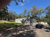 A charming single-story home with a well-maintained lawn and ample parking at 19875 Rose Rd, Altoona, FL 32702