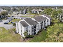 Aerial view of condos showcasing well-maintained landscaping and ample parking at 2130 Cascades Blvd # 101, Kissimmee, FL 34741