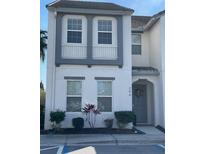 Charming two-story condo featuring gray trim, a welcoming front door, and neat landscaping at 294 Captiva Dr, Davenport, FL 33896