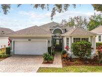 Charming single-story home with a well-manicured lawn and inviting brick pathway to the front door at 3782 Avon Ct, Clermont, FL 34711