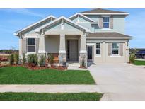 Charming two-story home with a covered front porch, landscaped yard, and neutral paint at 5306 Marshelder St, Apopka, FL 32712