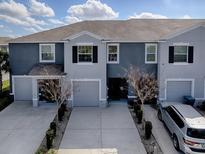 Charming townhome with a private driveway, attached garage, and manicured landscaping at 5391 Dragonfly Dr, Wildwood, FL 34785