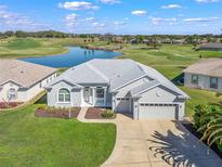 Stunning home showcasing lush landscaping and a picturesque golf course and water view at 17899 Se 115Th Cir, Summerfield, FL 34491