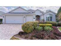 Charming single-story home with well-manicured landscaping and a three-car garage at 2022 Abordale Ln, The Villages, FL 32162