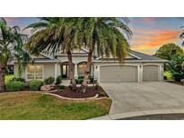 Beautiful single-story home showcasing well-maintained landscaping and an attached three-car garage at 2059 Landings Ln, The Villages, FL 32162