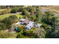 Expansive property featuring a home, outbuildings, RV, and a picturesque mix of open land and mature trees at 2610 Stephens Rd, Groveland, FL 34736