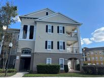 Attractive building exterior with private balcony and manicured landscaping under clear blue skies at 3605 Conroy Rd # 535, Orlando, FL 32839