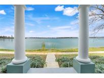 A serene lake view framed by pillars on a sunny day offers a tranquil and picturesque setting at 559 Juniper Springs Dr, Groveland, FL 34736