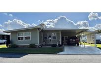 Charming single-story home with carport and well-maintained landscaping at 127 Hibiscus Way, Leesburg, FL 34748
