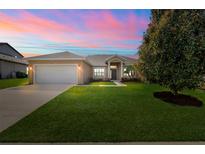 Charming one-story home with a well-manicured lawn, two car garage, and inviting front entrance at 16611 Spring Park Dr, Clermont, FL 34711