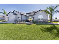 Charming single-story home with well-manicured lawn, attractive landscaping, and neutral-tone exterior at 17204 Se 112Th Court Rd, Summerfield, FL 34491