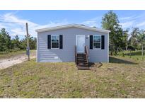 Charming single-Gathering home showcasing a well-maintained lawn, simple landscaping, and a welcoming entrance at 17442 Eve Dr, Montverde, FL 34756
