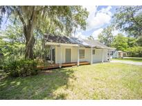 Charming single-story home featuring a covered carport and a front porch for relaxing outdoors at 2886 N C 470, Lake Panasoffkee, FL 33538