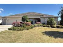 Charming single-story home with a well-manicured lawn and colorful landscaping at 2935 Cedar Grove Loop, The Villages, FL 32163