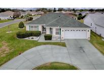 Well maintained single-story home featuring a circular driveway and manicured landscaping at 3067 Southern Trce, The Villages, FL 32162