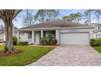 Charming single-story home with a two-car garage and well-maintained landscaping at 4110 Hammersmith Dr, Clermont, FL 34711