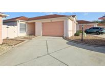 Exterior view of home showing a two-car garage and a well-maintained driveway at 731 Hernandez Dr, The Villages, FL 32159