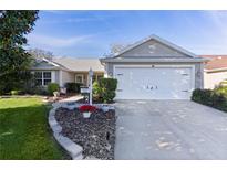 Charming single-story home with well-manicured landscaping and attached two-car garage at 8104 Se 177Th Winterthur Loop, The Villages, FL 32162