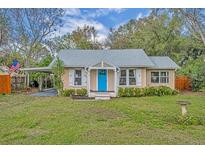 Charming single-story home with well-maintained lawn and inviting blue front door at 815 E 11Th Ave, Mount Dora, FL 32757