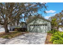 Charming single-story home featuring a two-car garage, manicured landscaping, and a welcoming entrance at 13219 Meadowlark Ln, Orlando, FL 32828