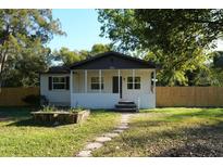 Charming single-story home with a cozy front porch and stone walkway leading to the entrance at 2210 Grant Ave, Eustis, FL 32726