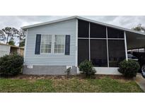 Charming single-story home featuring light siding and a screened in porch for outdoor enjoyment at 263 Pinewood Dr, Eustis, FL 32726