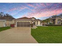 Charming single-Gathering home featuring a well-manicured lawn, a two-car garage, and a warm inviting entrance at 4835 Kelso St, Leesburg, FL 34748