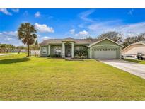 Charming single-story home with a well-manicured lawn and inviting curb appeal at 14736 Pine Cone Trl, Clermont, FL 34711