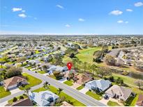 Expansive aerial view of a home in a golf course community with beautiful landscaping at 3163 Southern Trce, The Villages, FL 32162